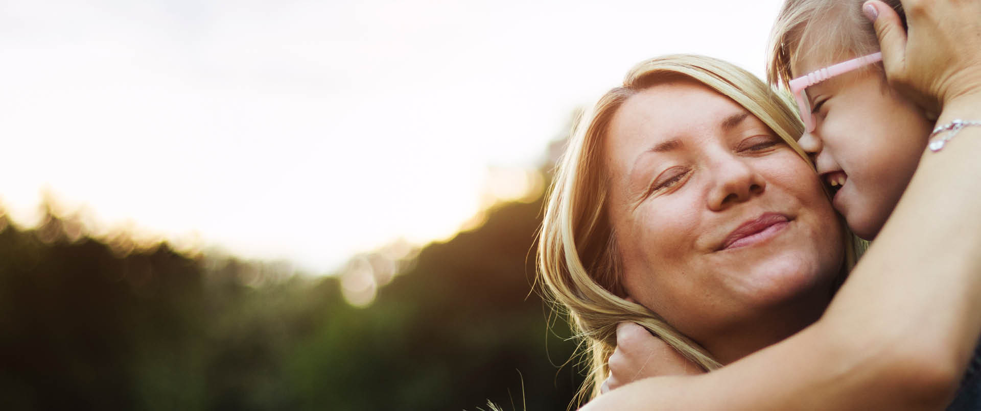 Mother lovingly hugging daughter