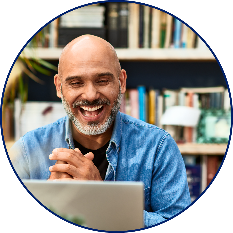 Cheerful handsome mature man at home speaking on video call using laptop, happiness, carefree, relaxation, communication