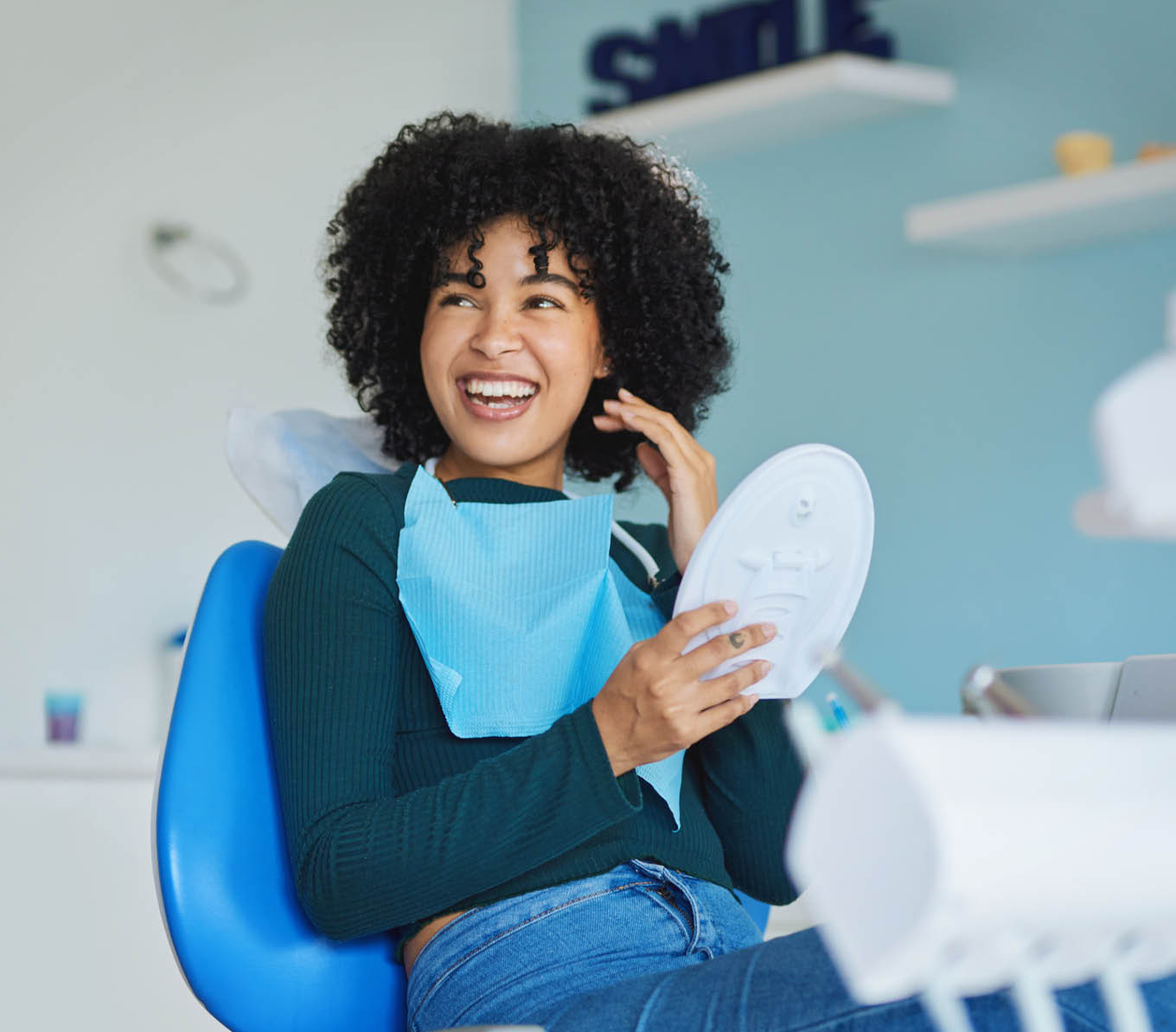 Shot of a young woman admiring her teeth after having a dental procedure done
