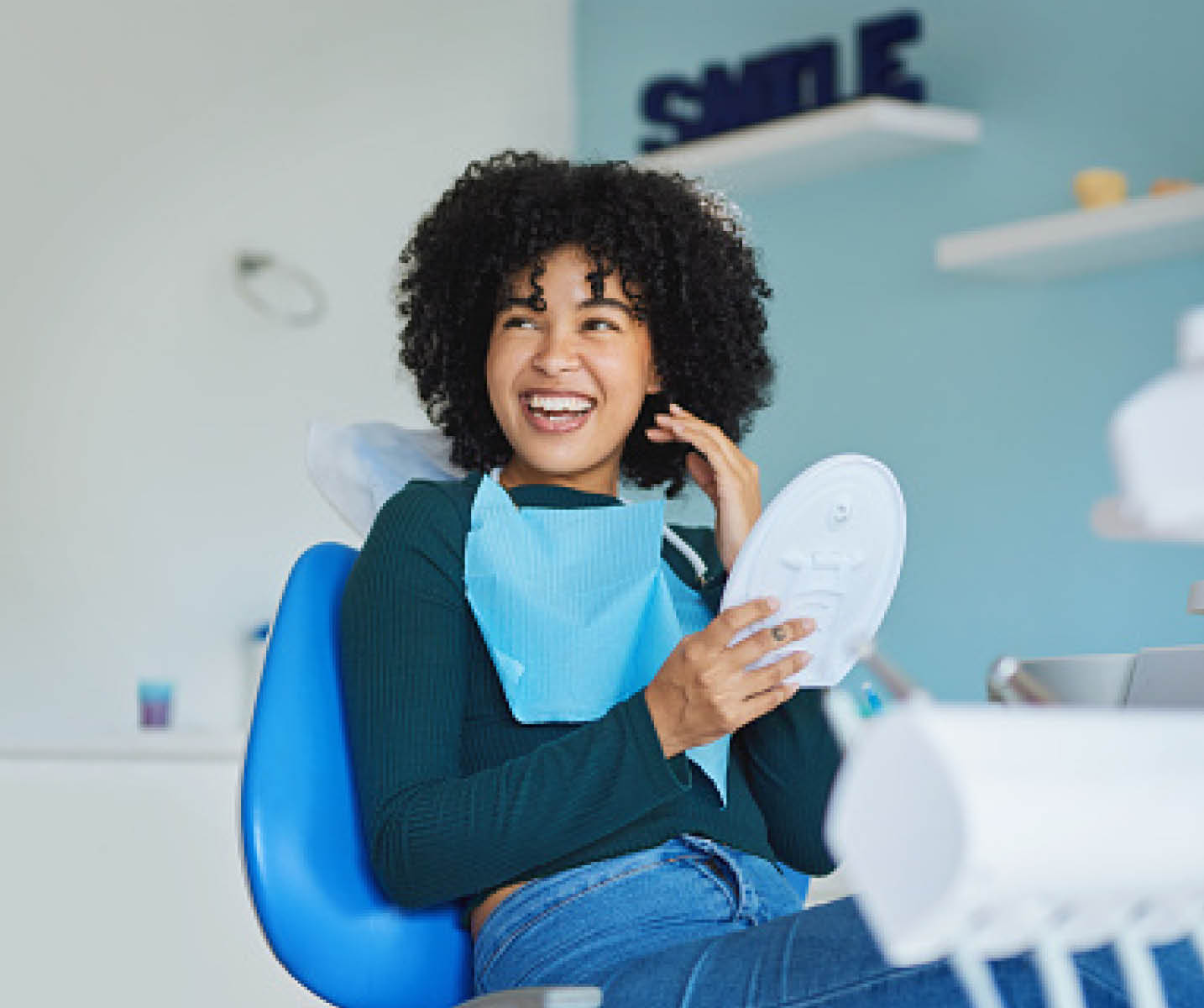 Shot of a young woman admiring her teeth after having a dental procedure done