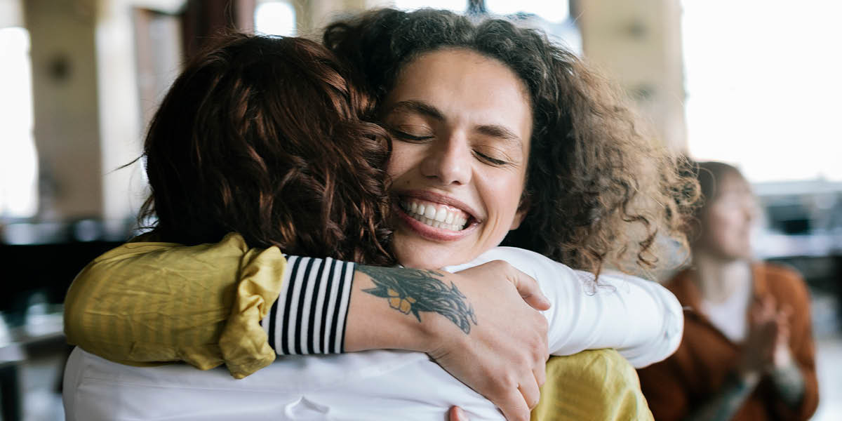 Photo of two women admiring baby bump