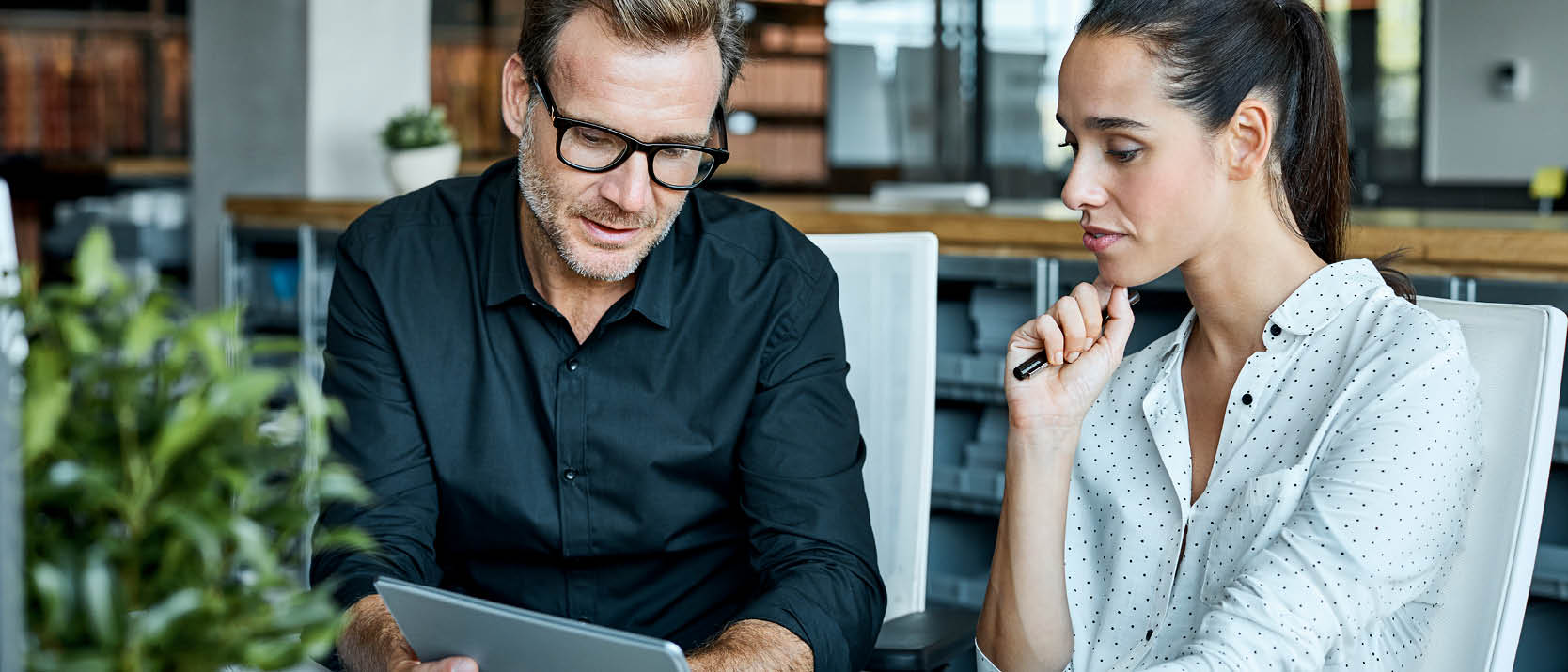 Photo of co-workers looking at computer