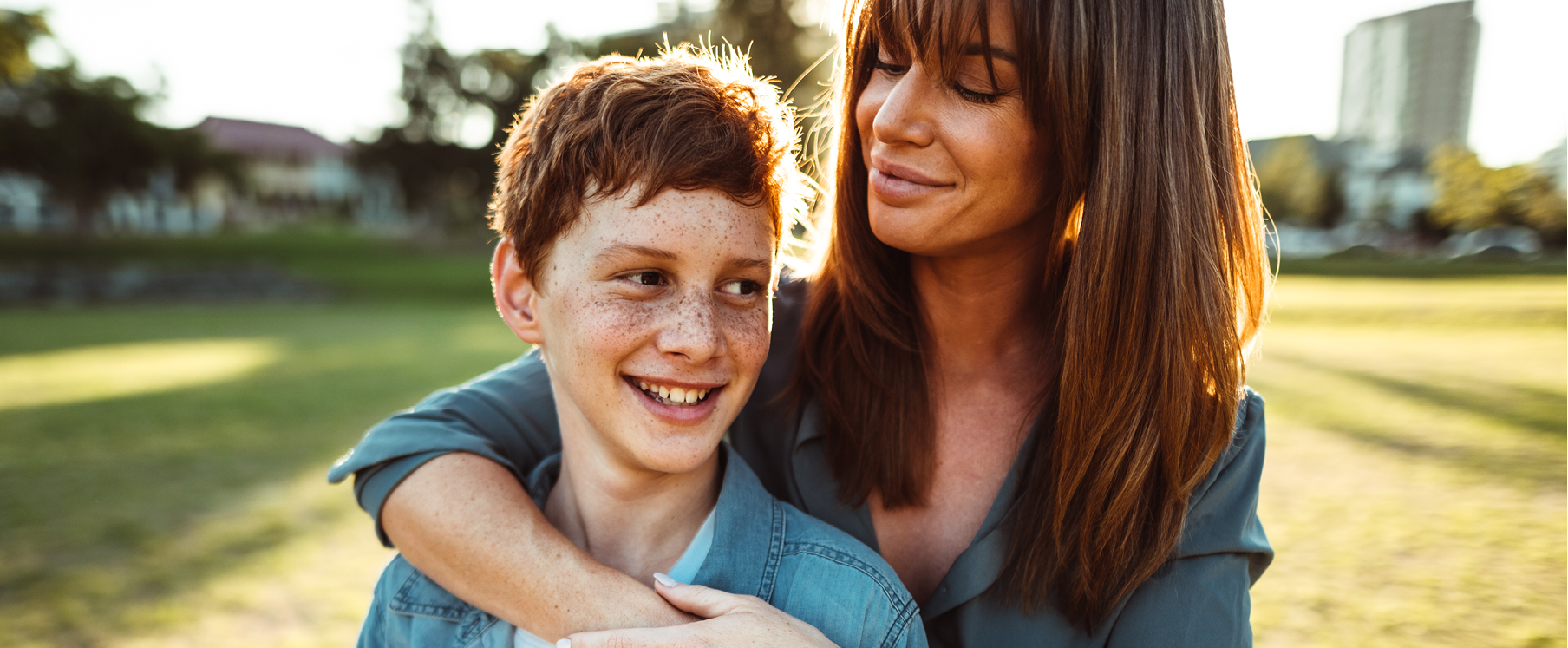 Photo of a father carrying his daughter on his shoulders