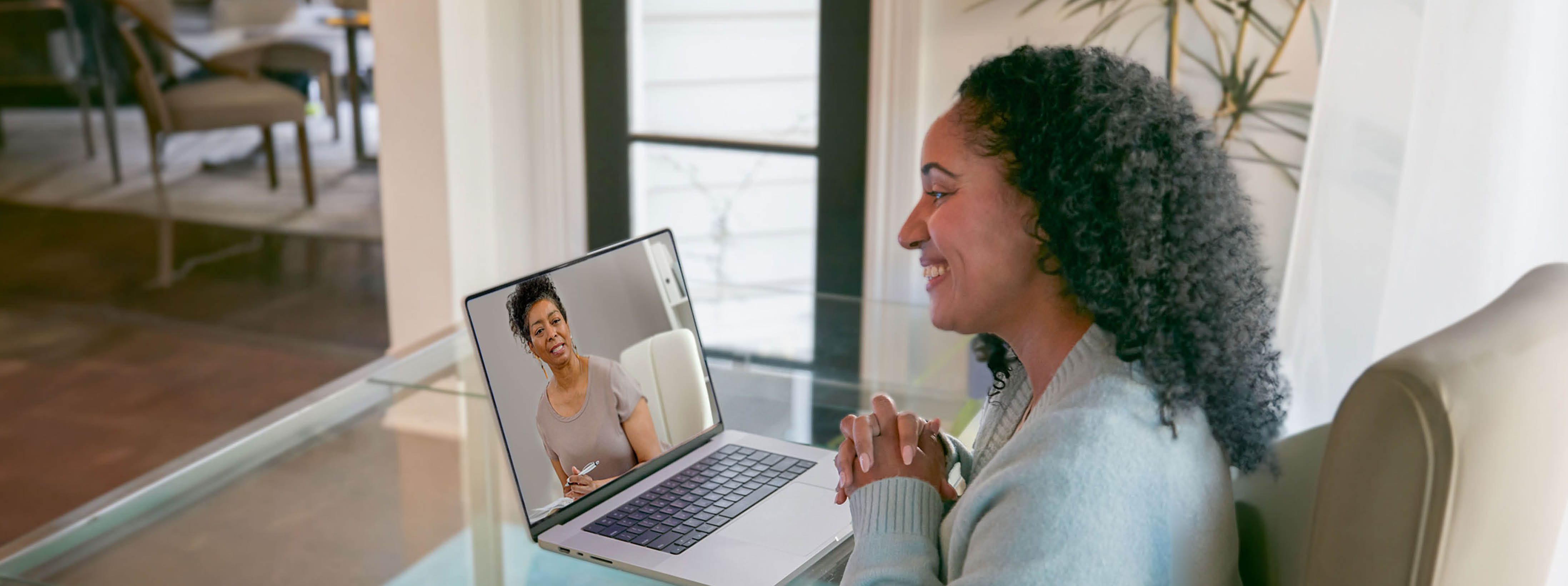 A woman is having a telehealth session with her behavioral health provider.