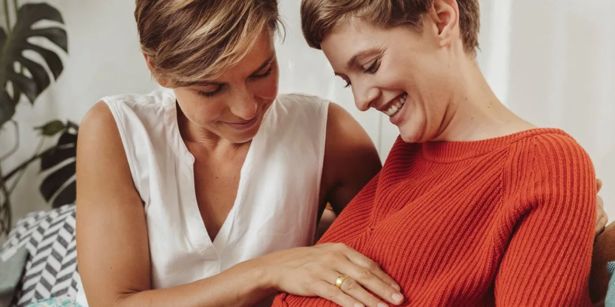 Photo of two women admiring baby bump