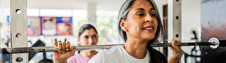 Mature woman doing exercises at gym
