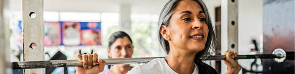 Mature woman doing exercises at gym