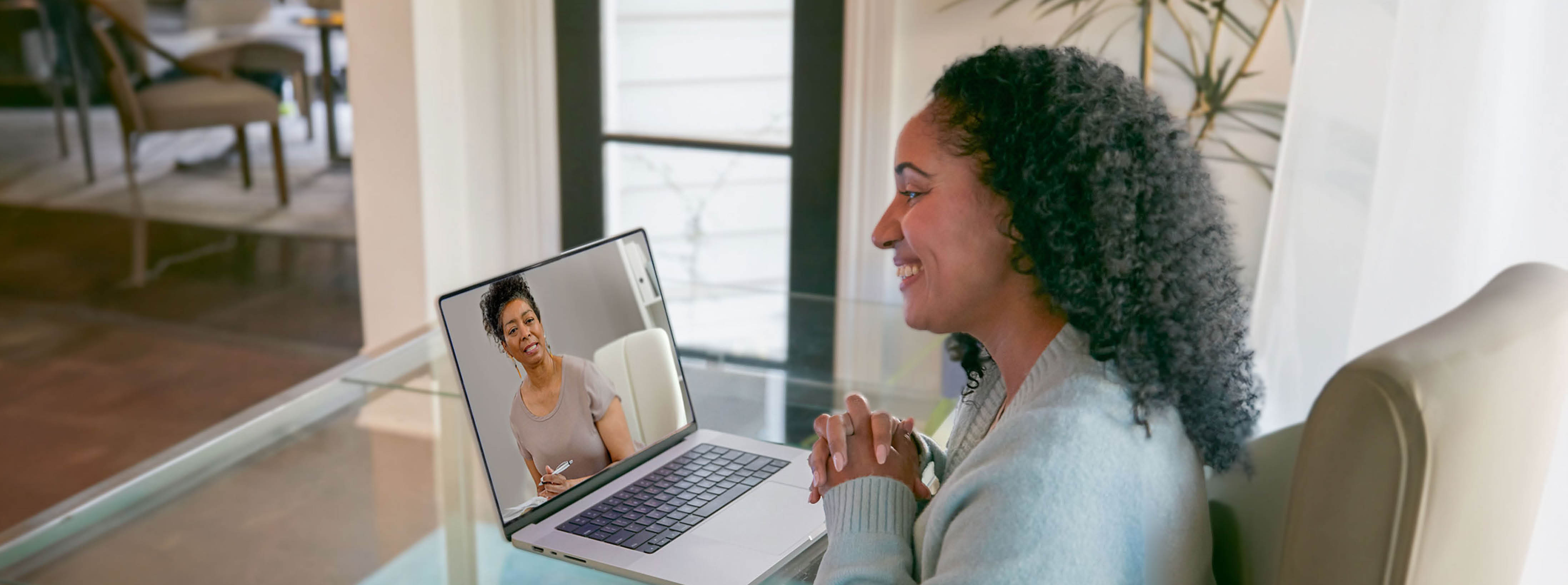 A woman is having a telehealth session with her behavioral health provider.